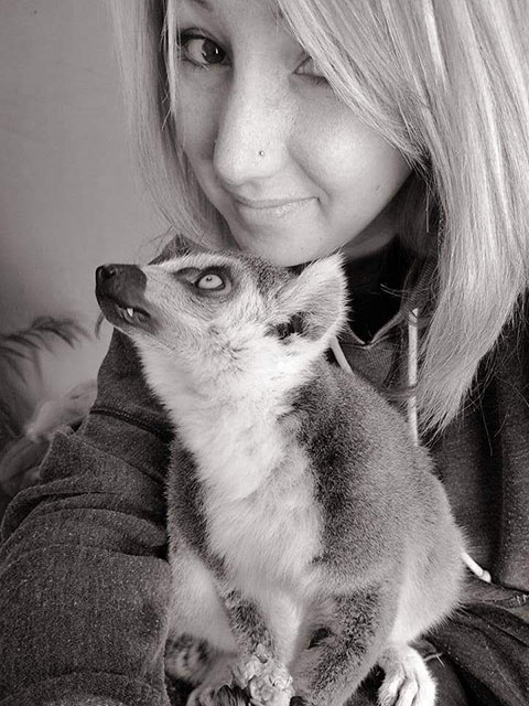 Woman posing with lemur