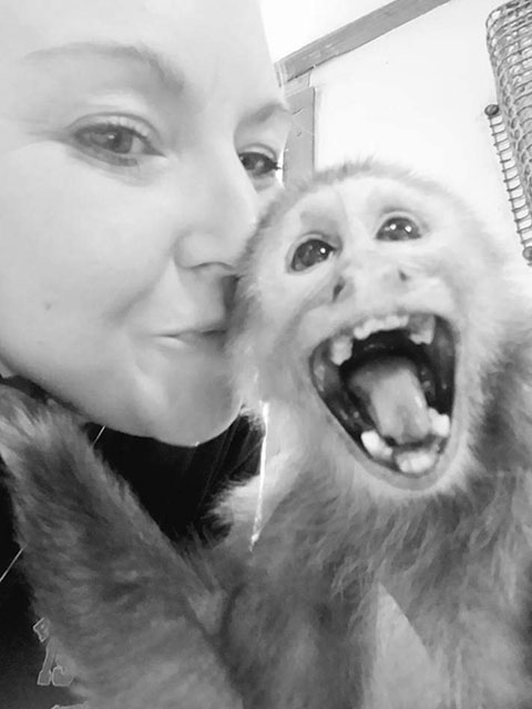 Monkey smiling with woman